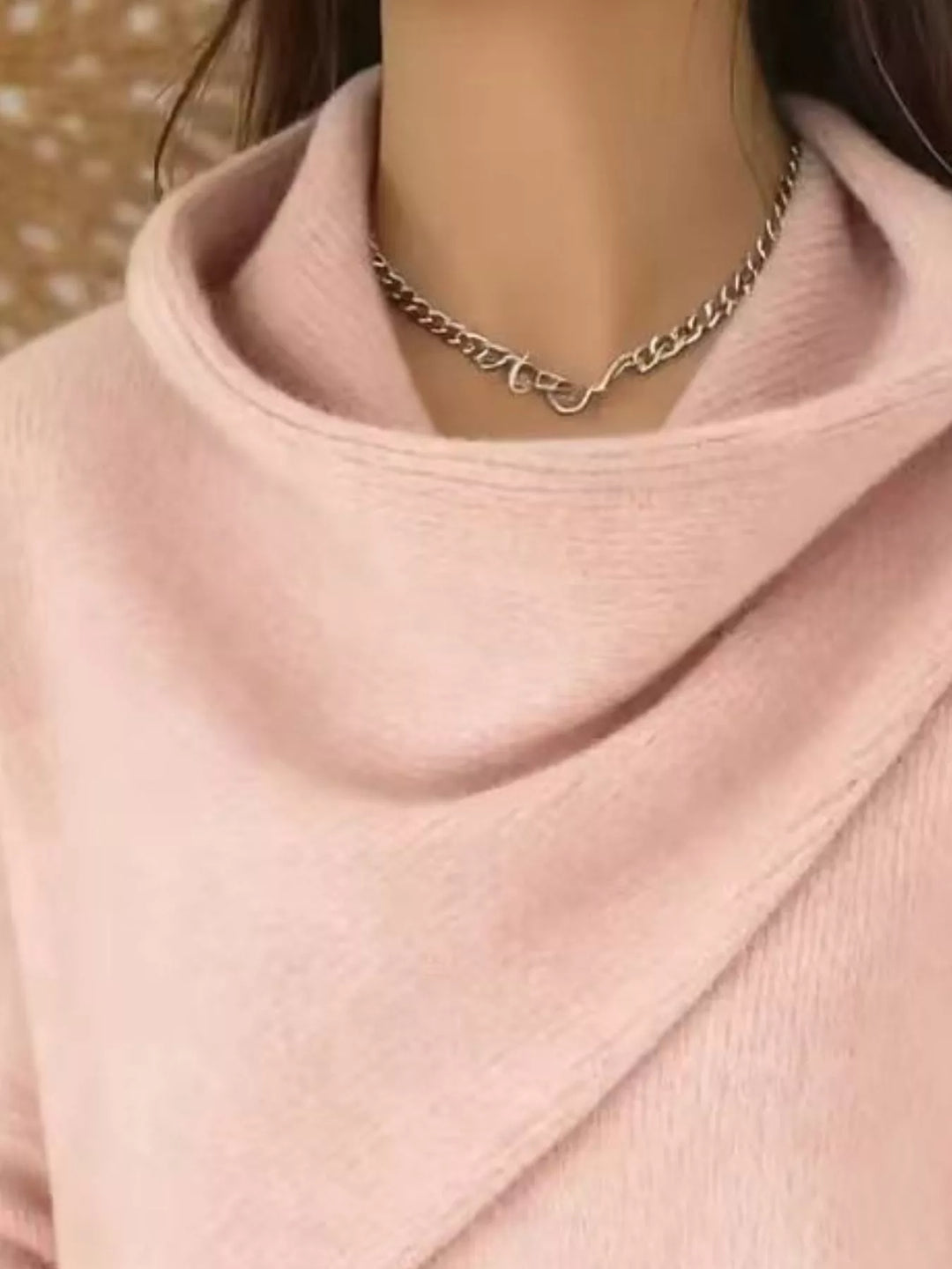 Draped diagonal cowl neck ribbed hem in watermelon pink, close-up detail