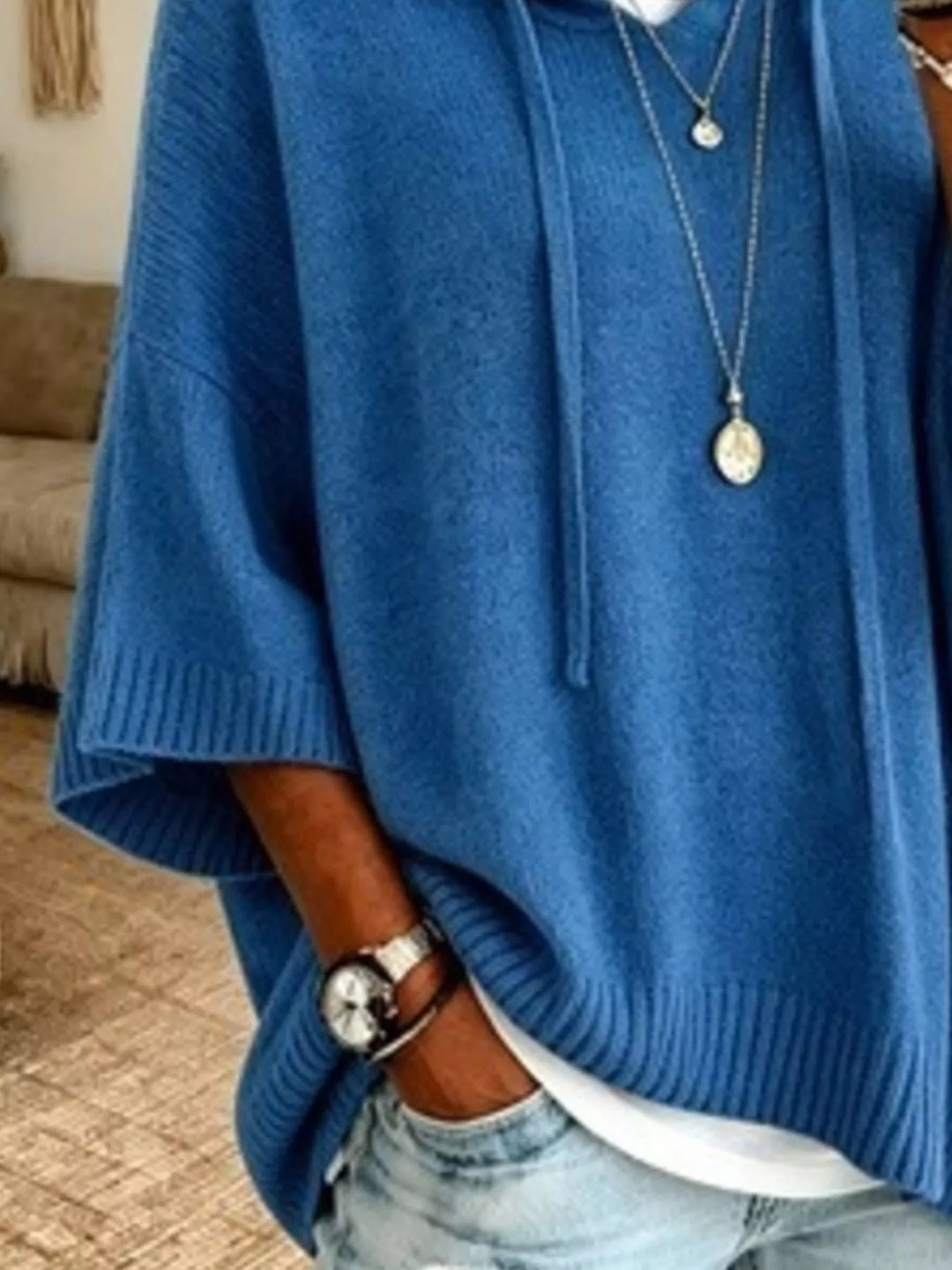 Blue knit sweater close-up of the ribbed hem and wide sleeve