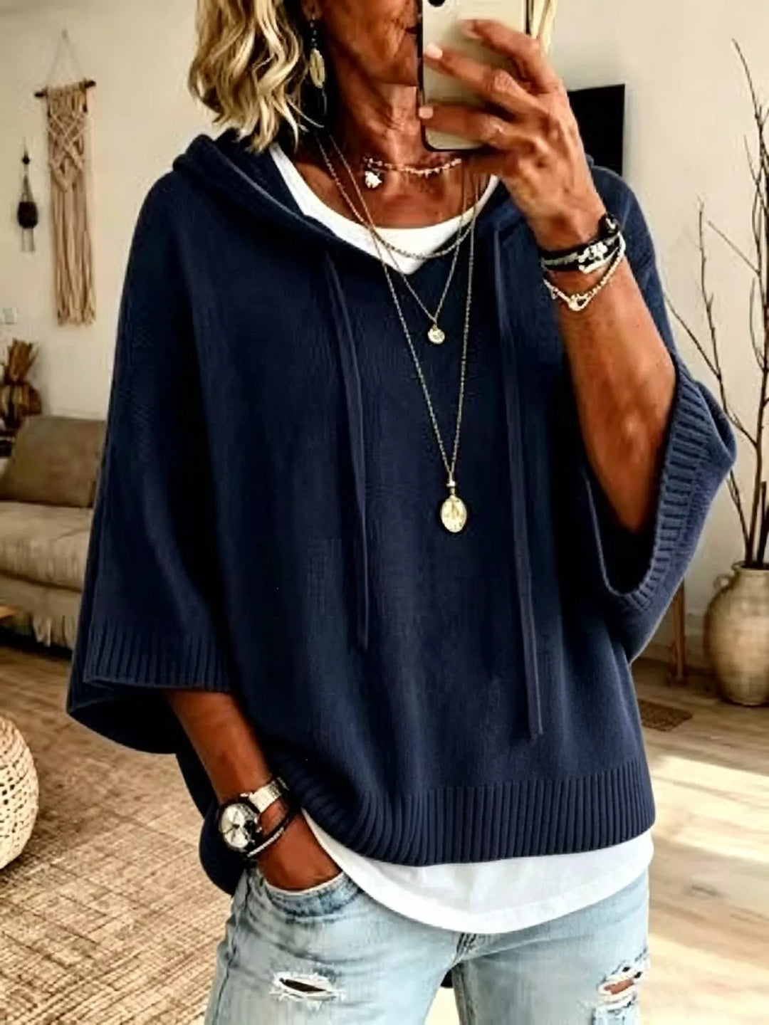 Navy batwing sleeve hooded sweater styled with light distressed jeans