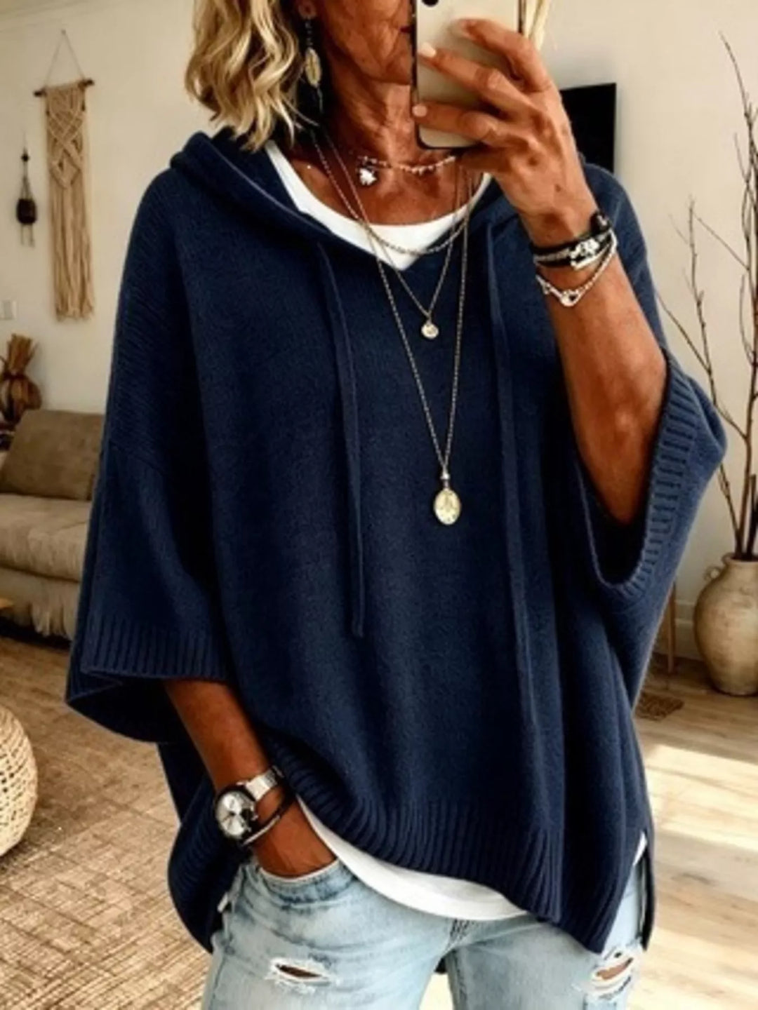 Navy hooded knit sweater with drawstrings and relaxed batwing sleeves