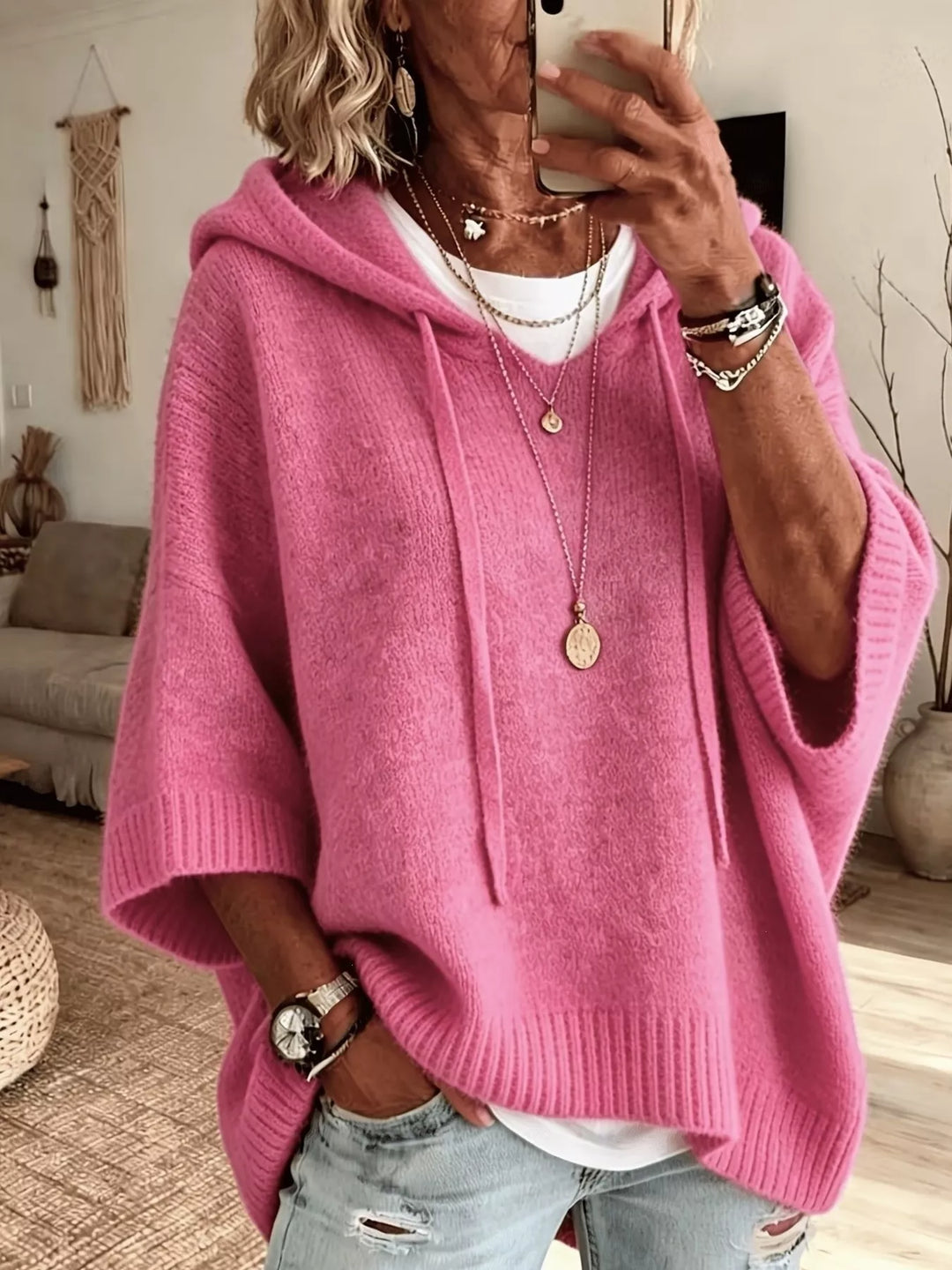 Pink hooded knit sweater with drawstrings and wide batwing sleeves
