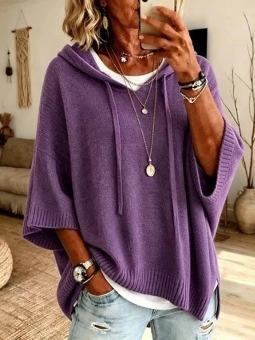 Purple hooded knit sweater with batwing sleeves and drawstrings, front view
