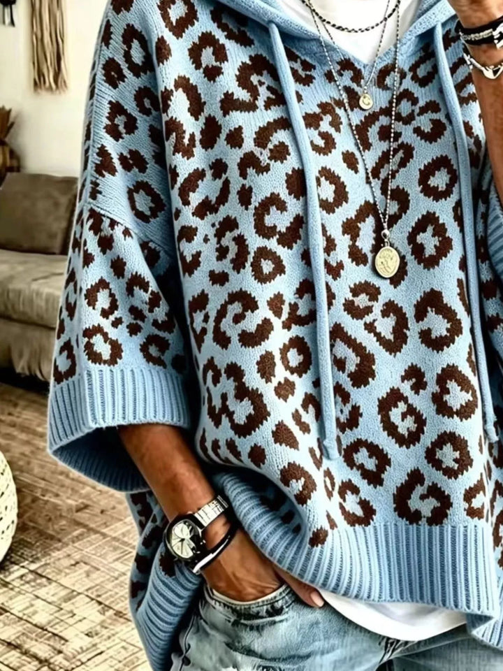 Hooded leopard print poncho style in blue, close-up detail