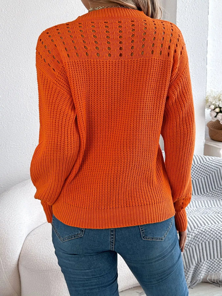 Back view of the orange pullover with openwork yoke detail