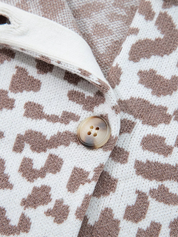 Close-up of a button and leopard print pattern on the ivory cardigan