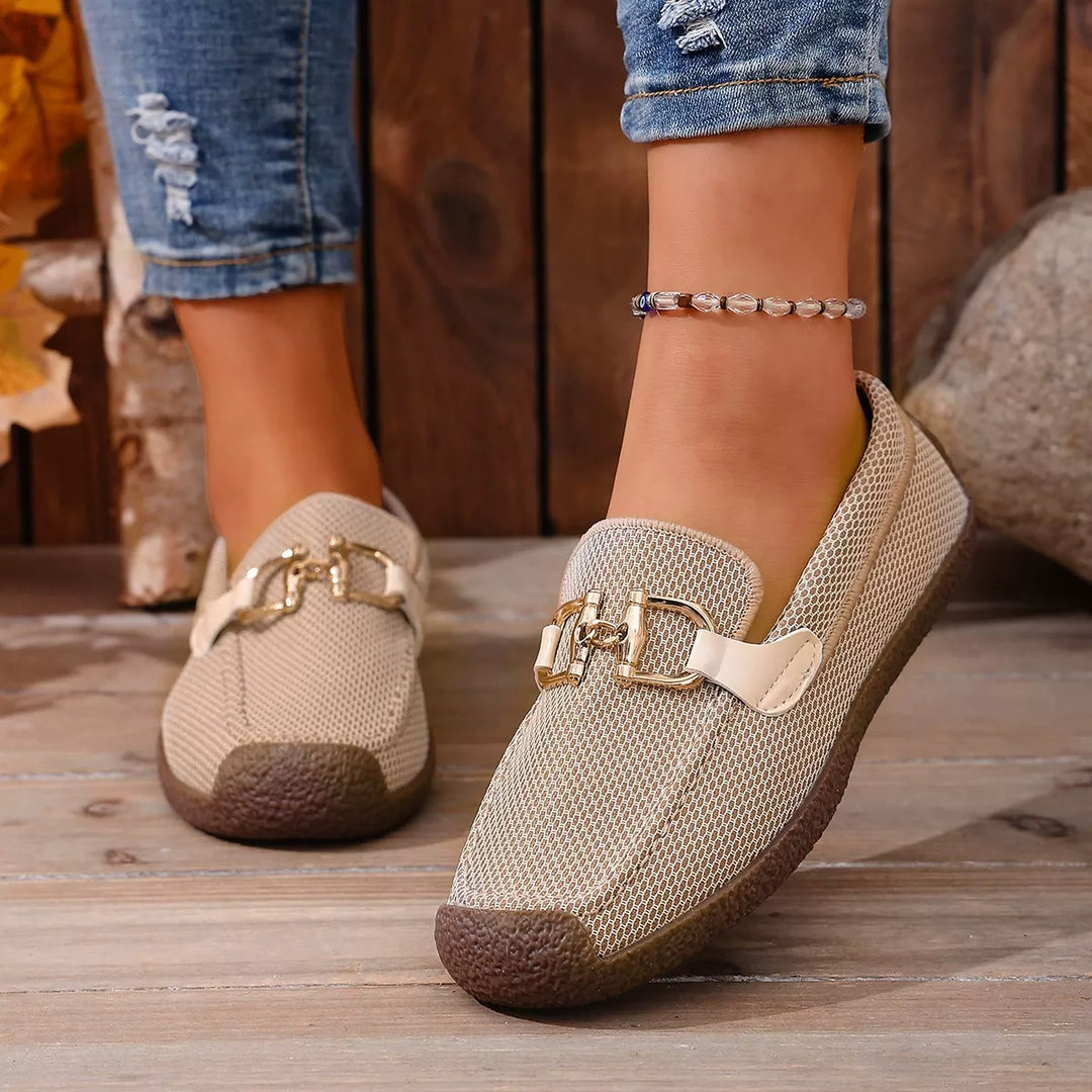 Beige slip on loafers with gold buckle, worn with cuffed jeans