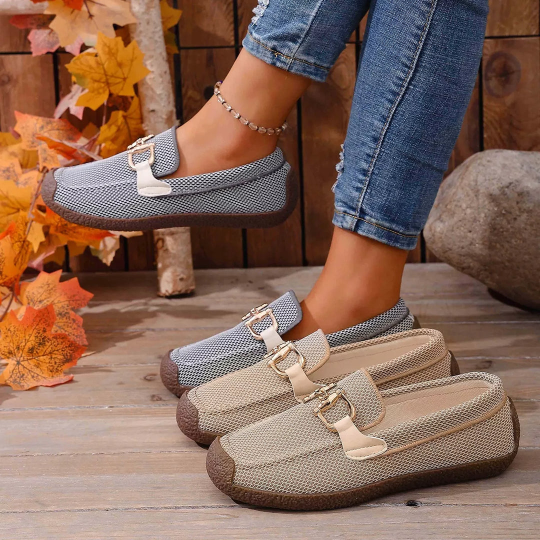 Women's loafers in gray and beige, comfortable slip on buckle flats, on a wooden deck