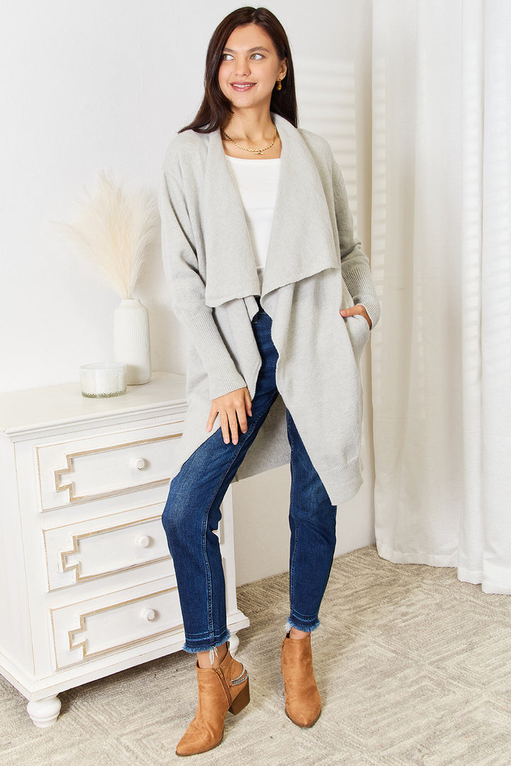 Full length light gray open front cardigan styled with jeans and ankle boots