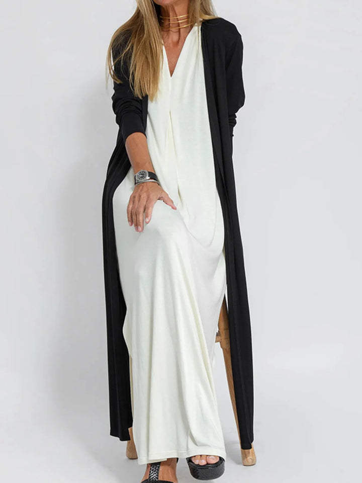 Black long cardigan with side slits over a white maxi dress