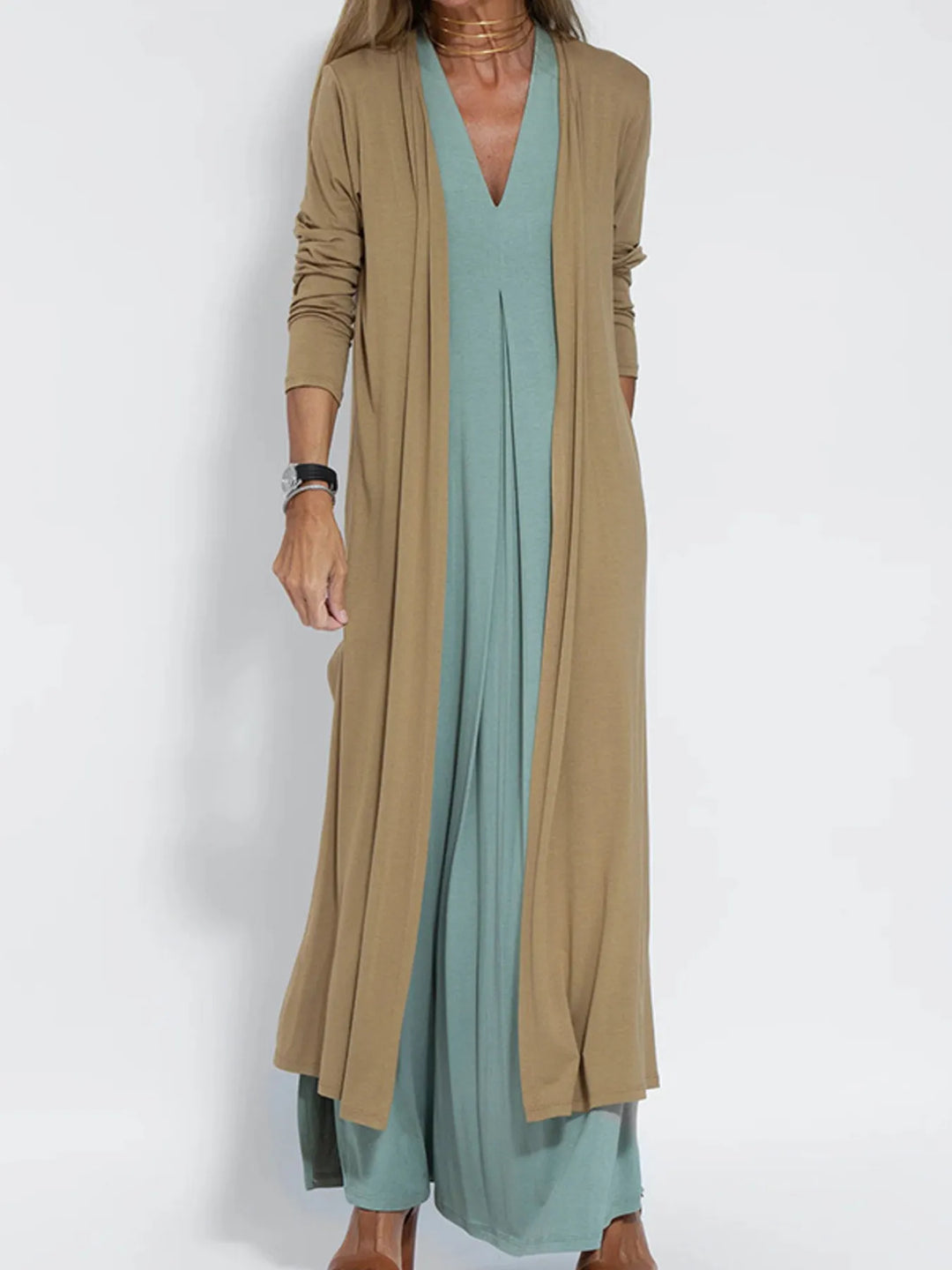Caramel long cardigan worn open over a sage green maxi dress
