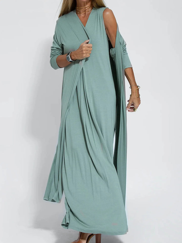 Sage green duster cardigan worn open, standing with a hand at the sleeve