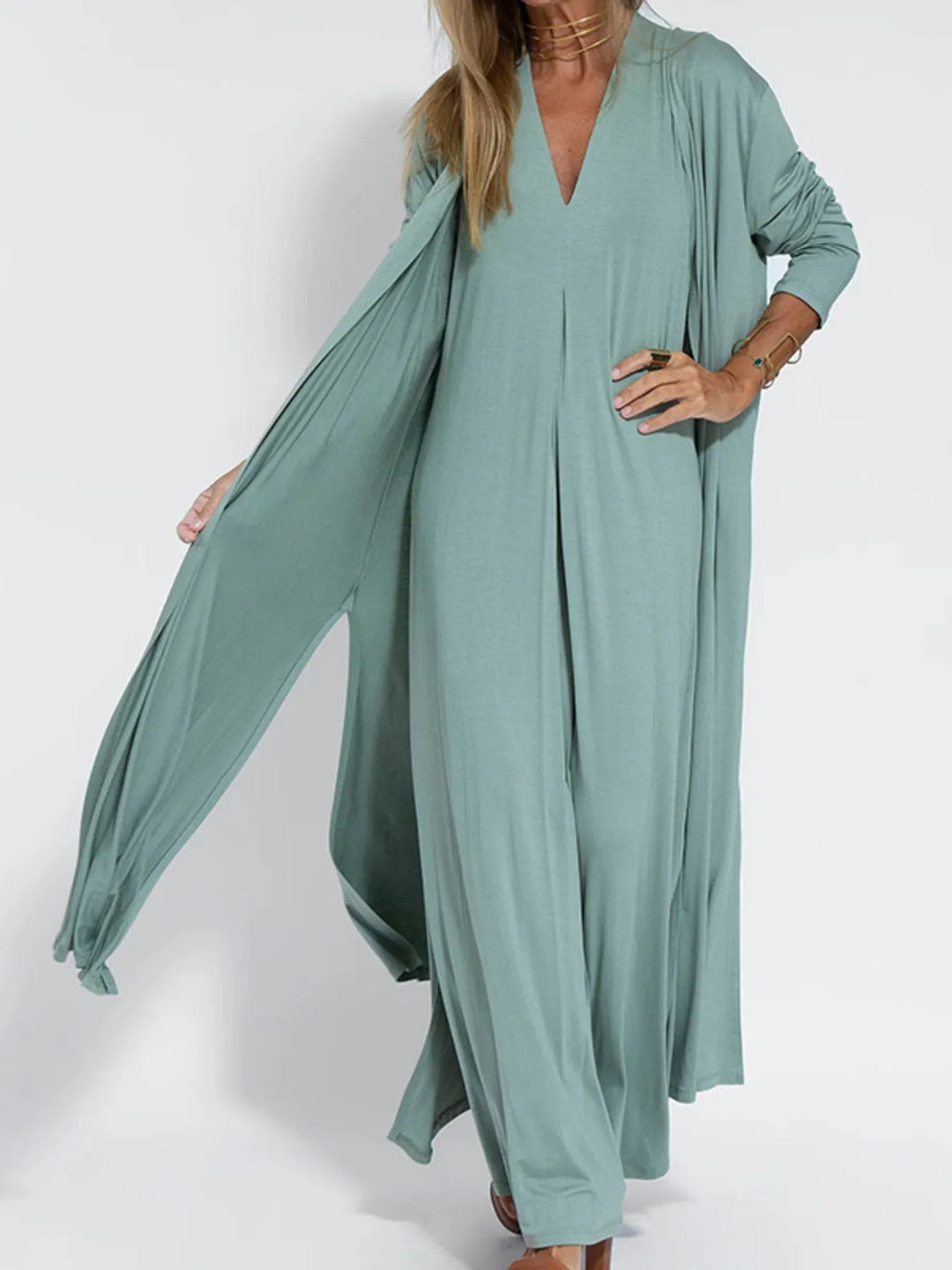 Sage green open front cardigan with a hand on the hip