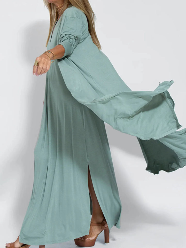 Sage green long cardigan flowing in motion, showing the side slit