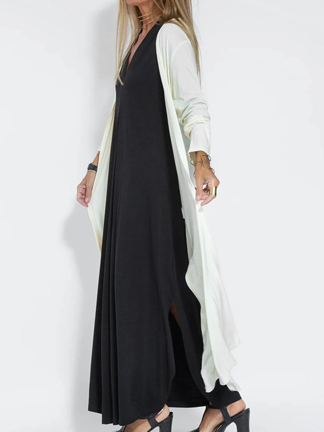 White duster cardigan in a side view draping over a black dress