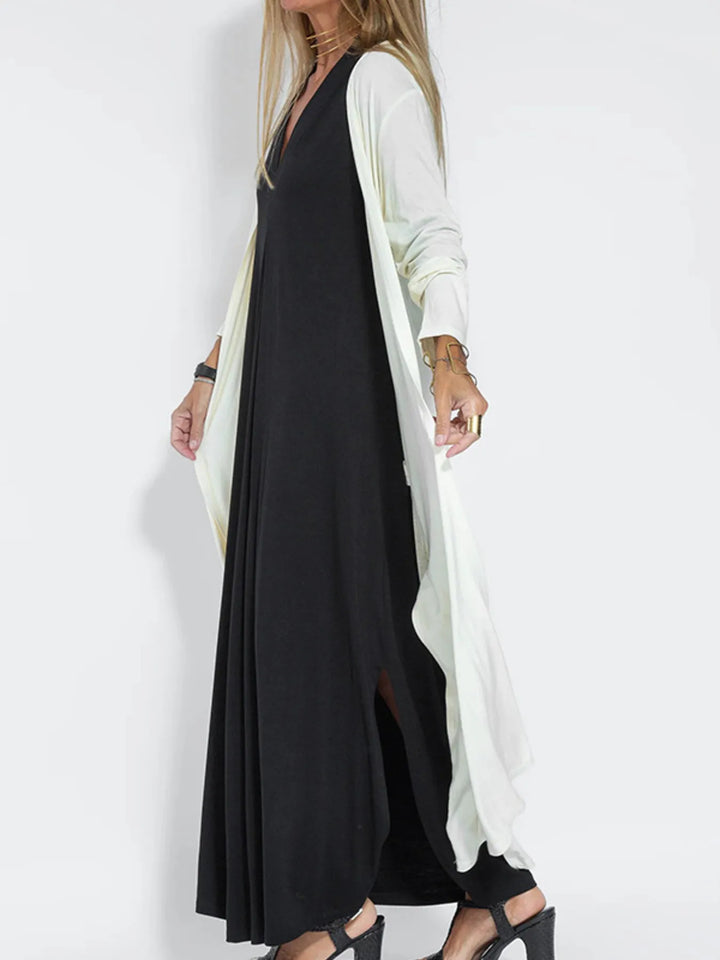 White duster cardigan in a side view draping over a black dress