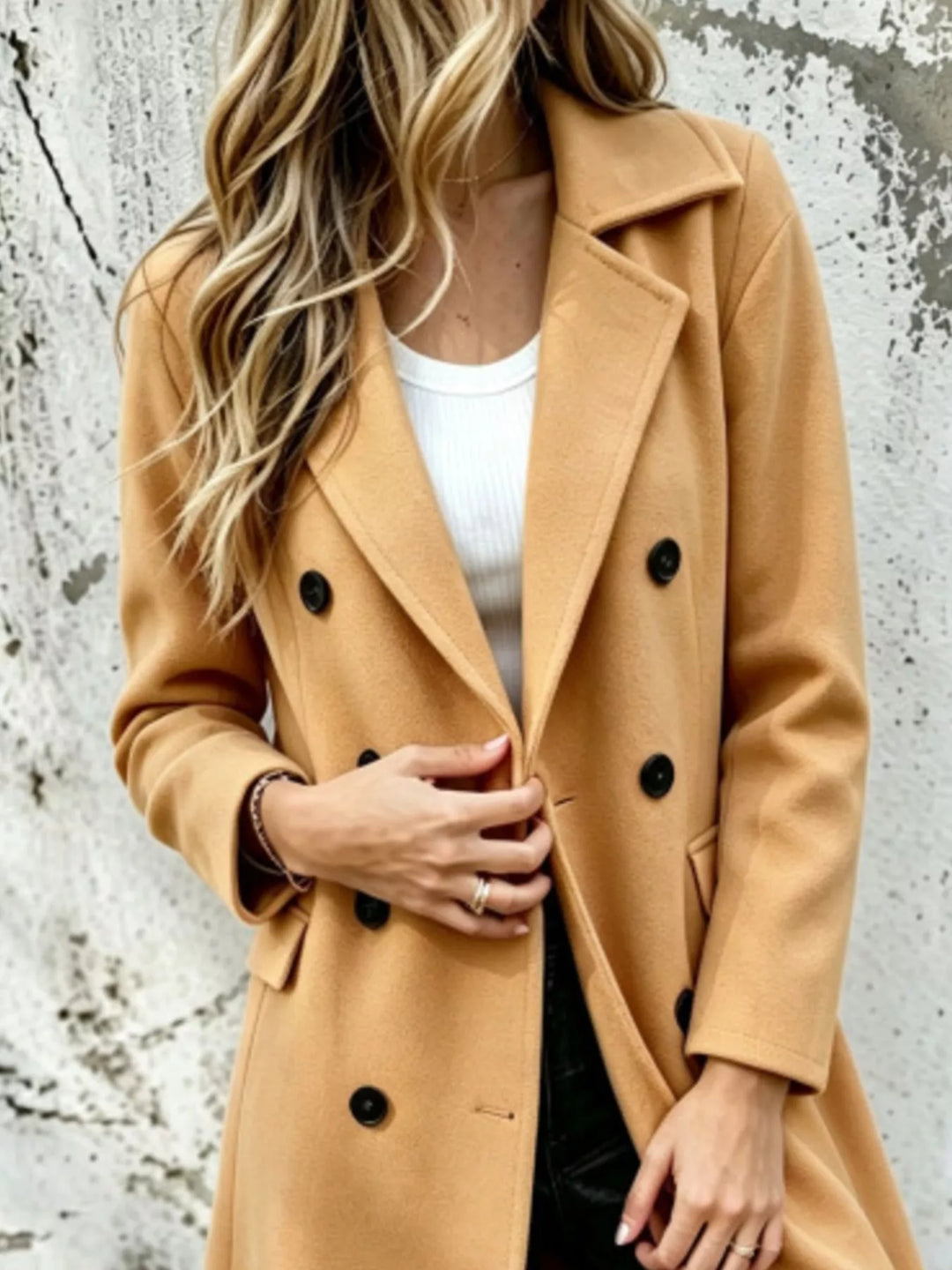 Camel double breasted coat close-up of the lapel collar and black buttons