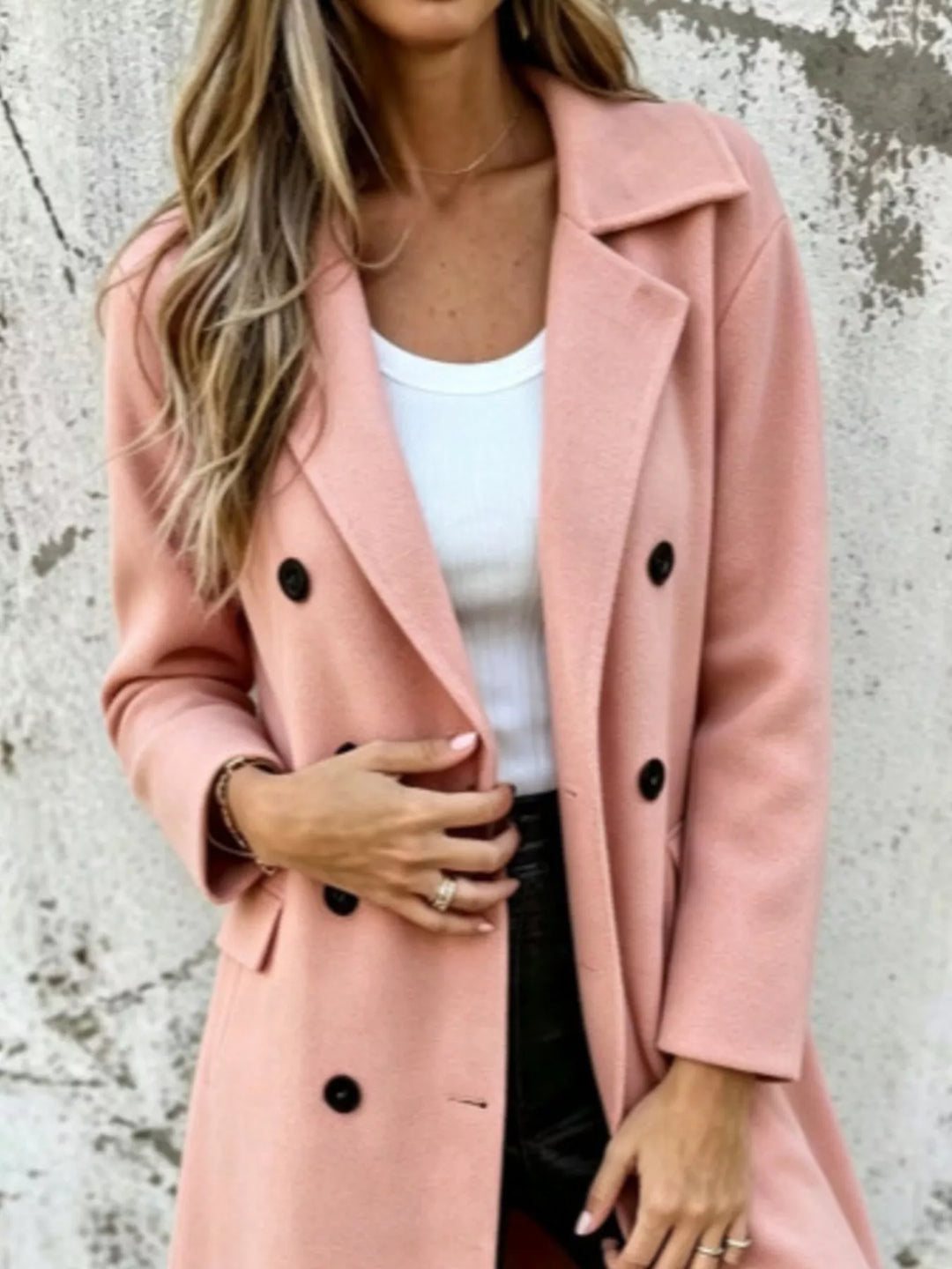 Pink long coat close-up of the lapel collar and black buttons