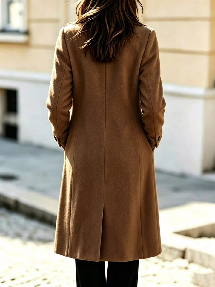 Back view of the camel mid calf coat with a center vent