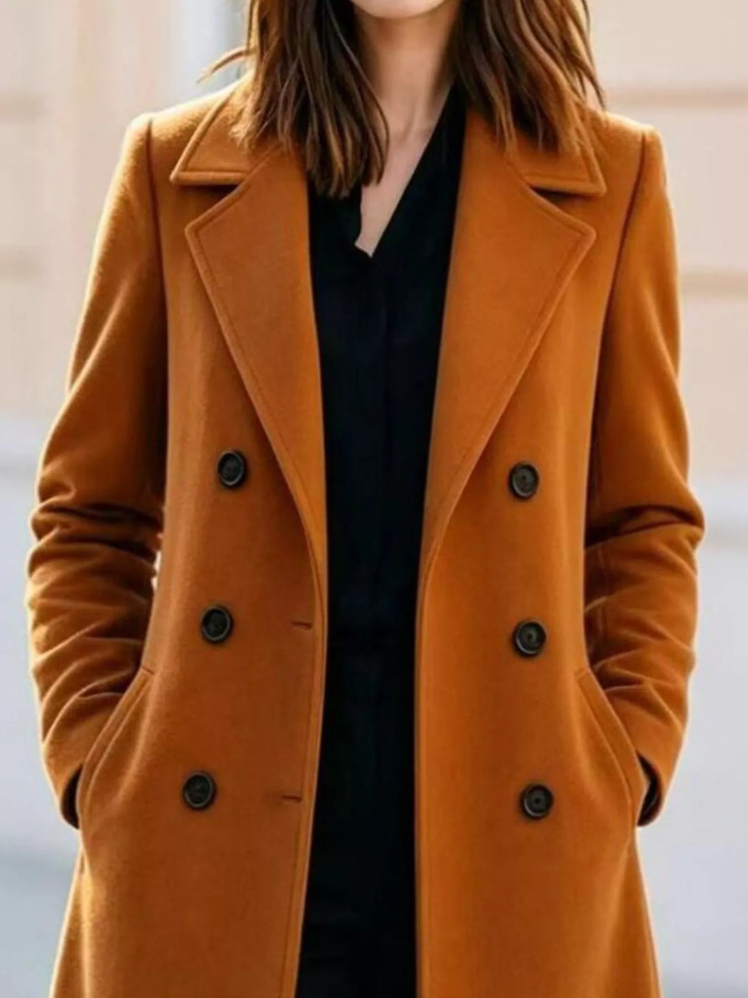 Close-up of the cognac coat double breasted buttons and wide lapel