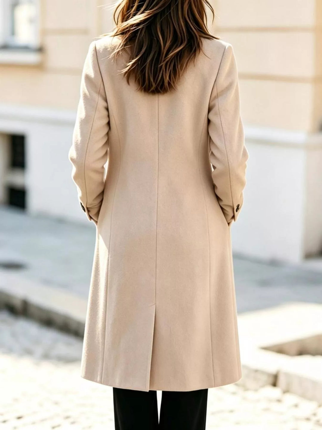 Back view of the cream mid calf long coat with a rear vent