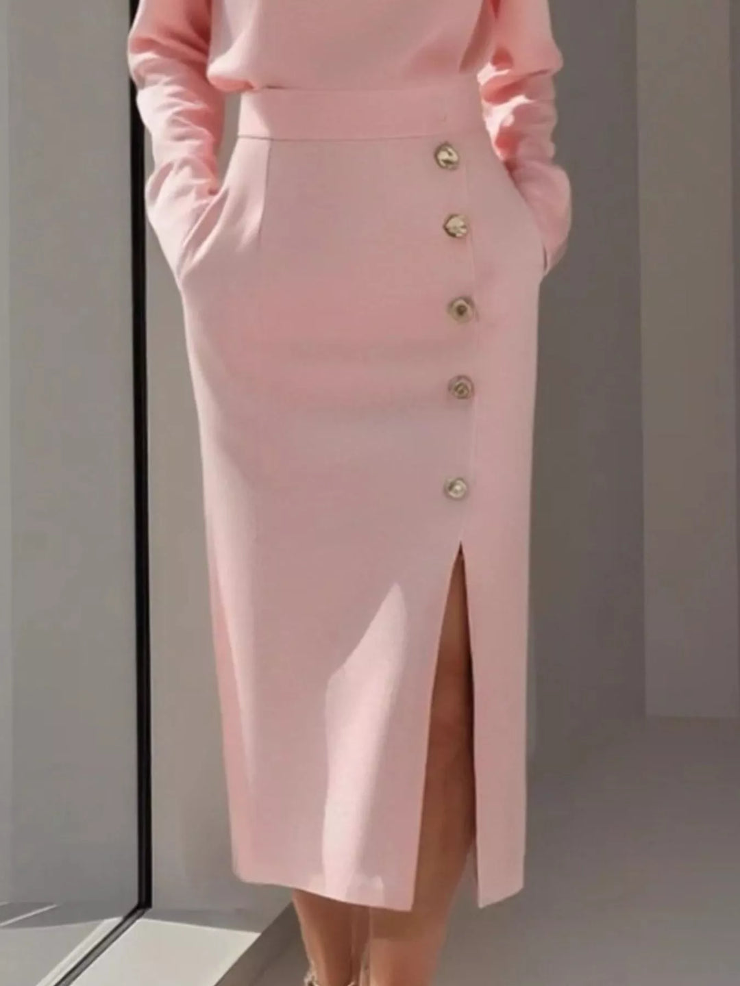 Round neck side button slit pockets in pink, close-up detail