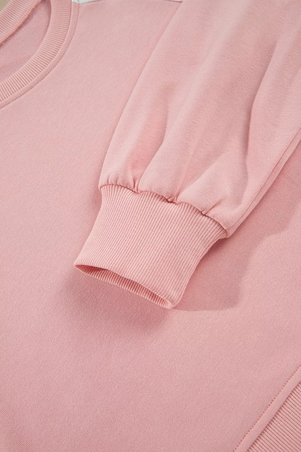 Close-up of the blush sweatshirt ribbed cuff and sleeve