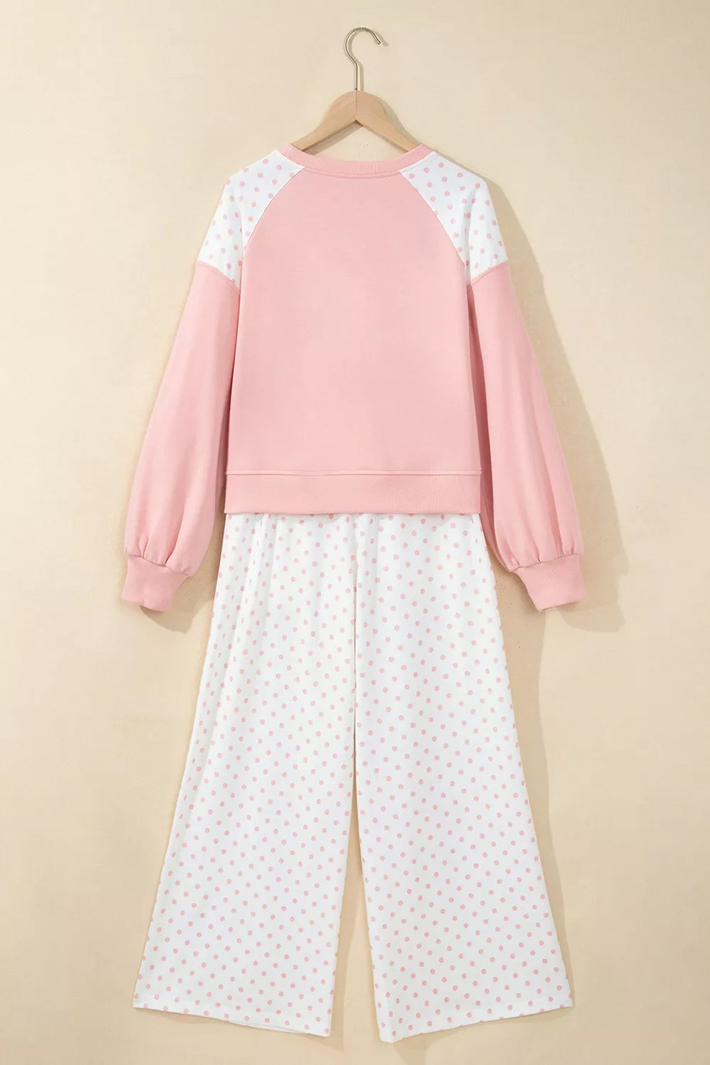 Back of the blush lounge set on a hanger with raglan sleeves and polka dot pants