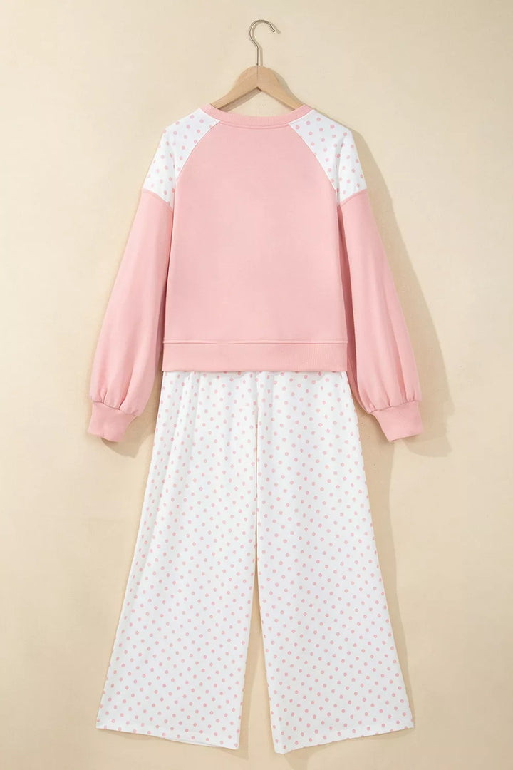 Back of the blush lounge set on a hanger with raglan sleeves and polka dot pants