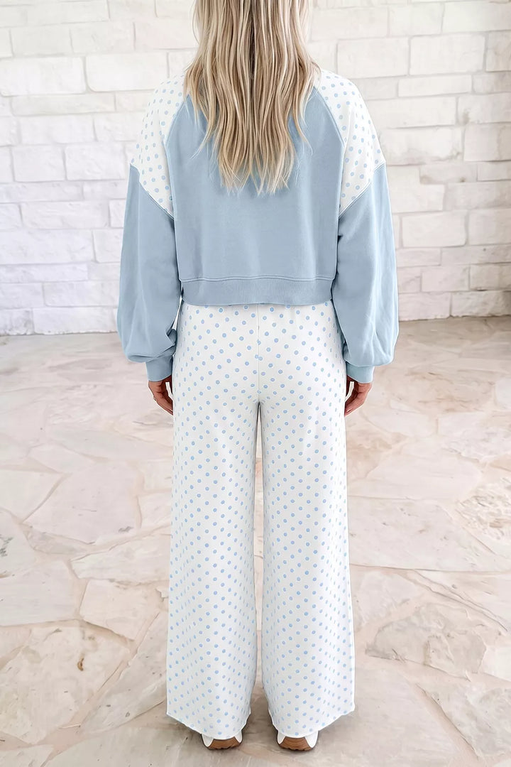 Back view of the light blue cropped sweatshirt and polka dot pants