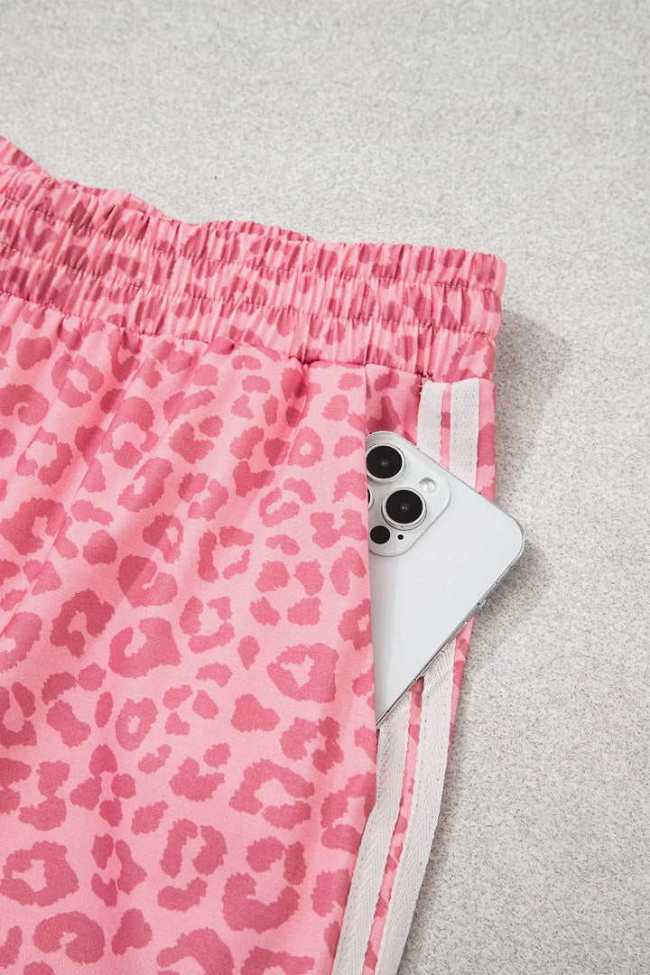 Detail of pink leopard wide leg pants with side pocket and white stripe