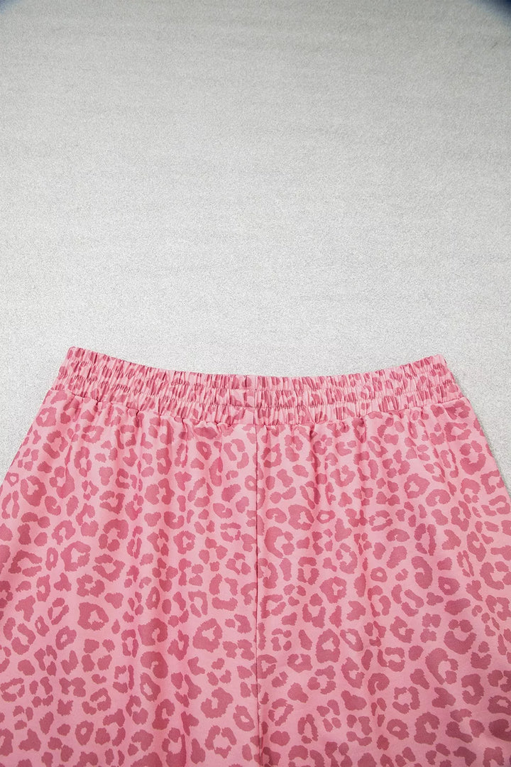 Close-up of elastic waistband on pink leopard print wide leg pants