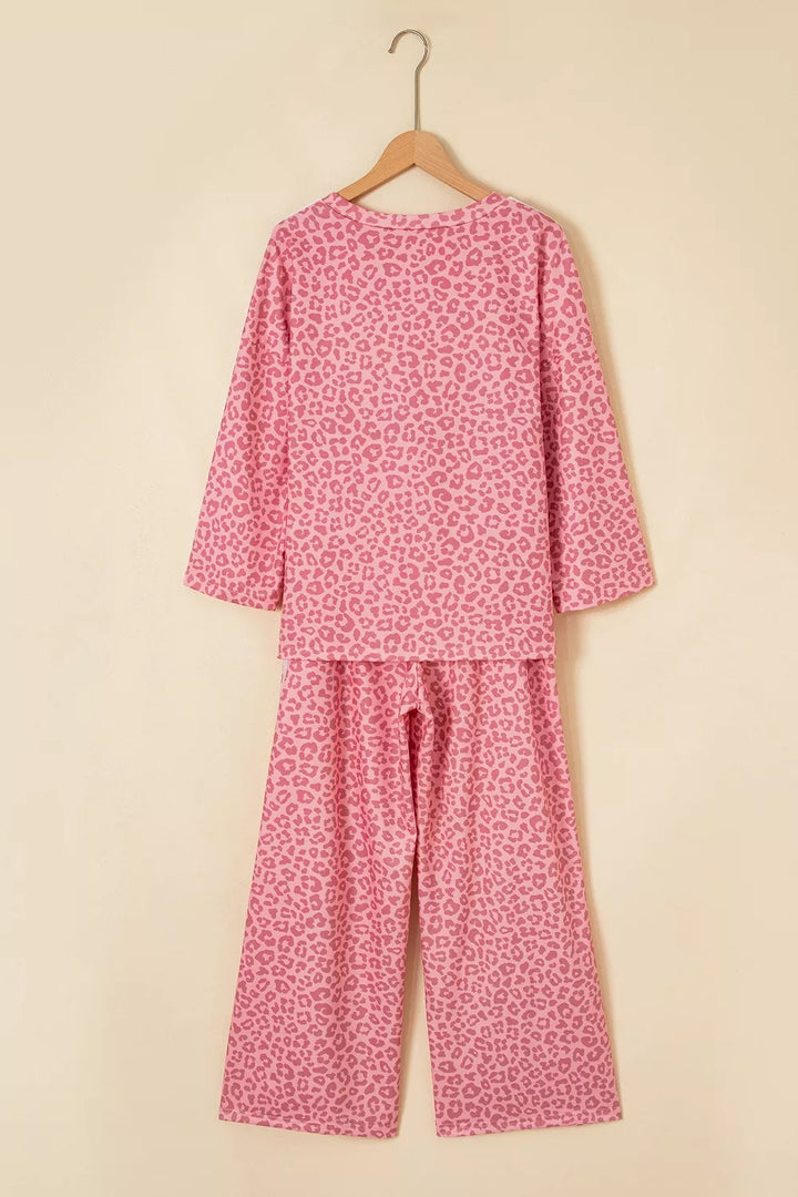 Back view of pink leopard lounge set top and pants on a hanger
