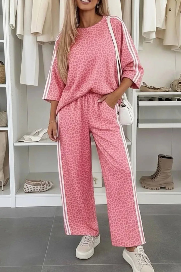 Women's lounge set in pink leopard print, top and wide leg pants with side stripes