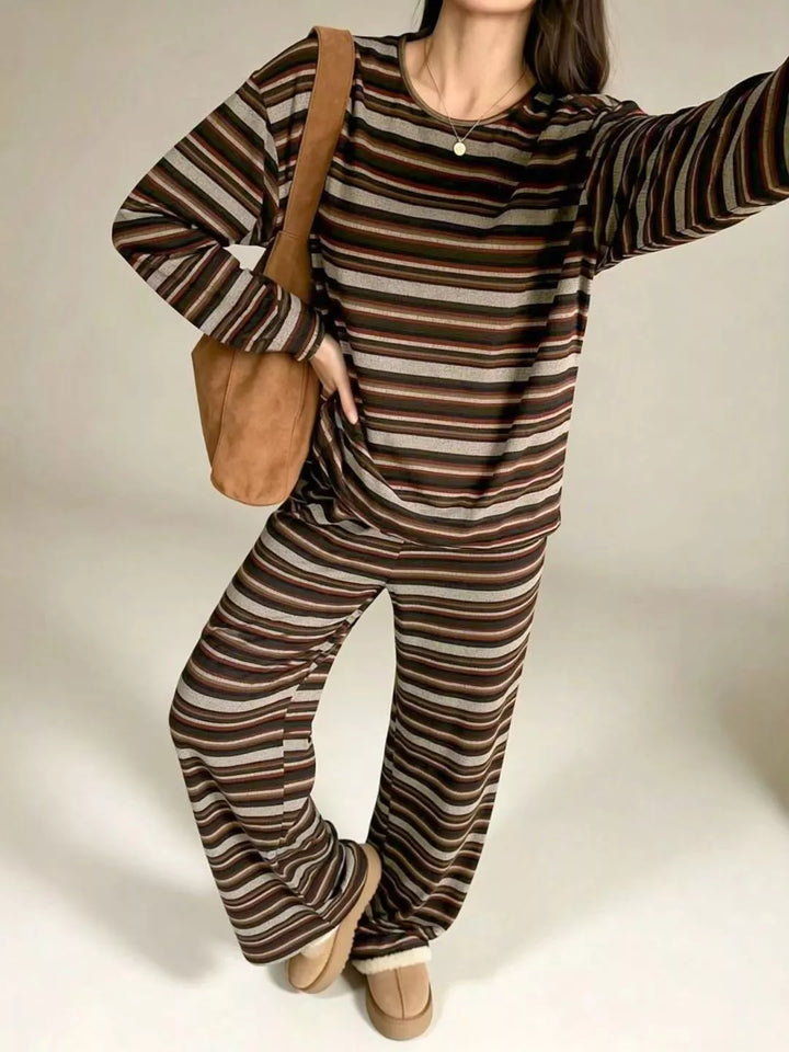 Women's lounge set in brown stripe, long sleeve top with pull on pants, carrying a tote