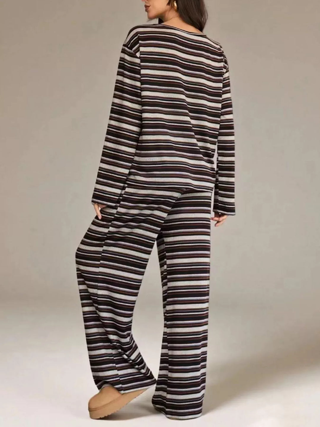 Plum stripe top and pants set in a three quarter turn, hand in pocket