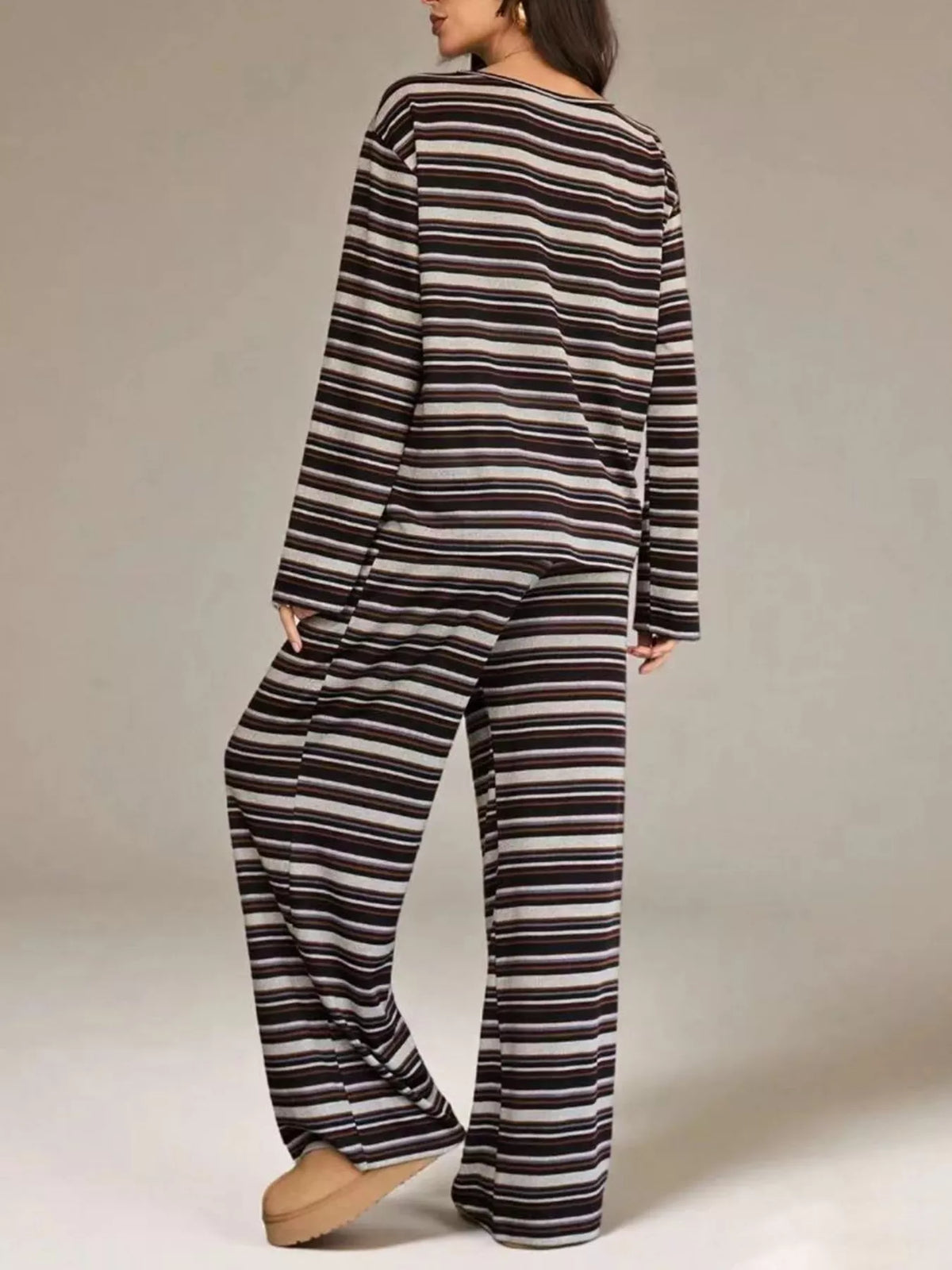 Plum stripe top and pants set in a three quarter turn, hand in pocket