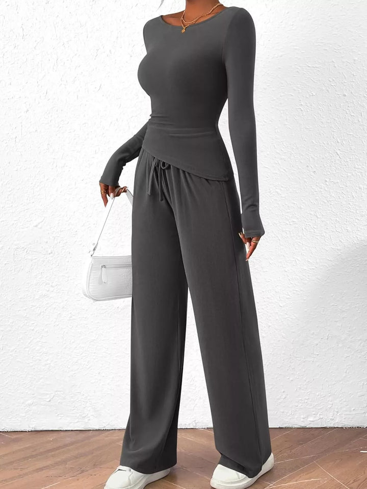 Charcoal lounge set styled with a small white handbag and sneakers
