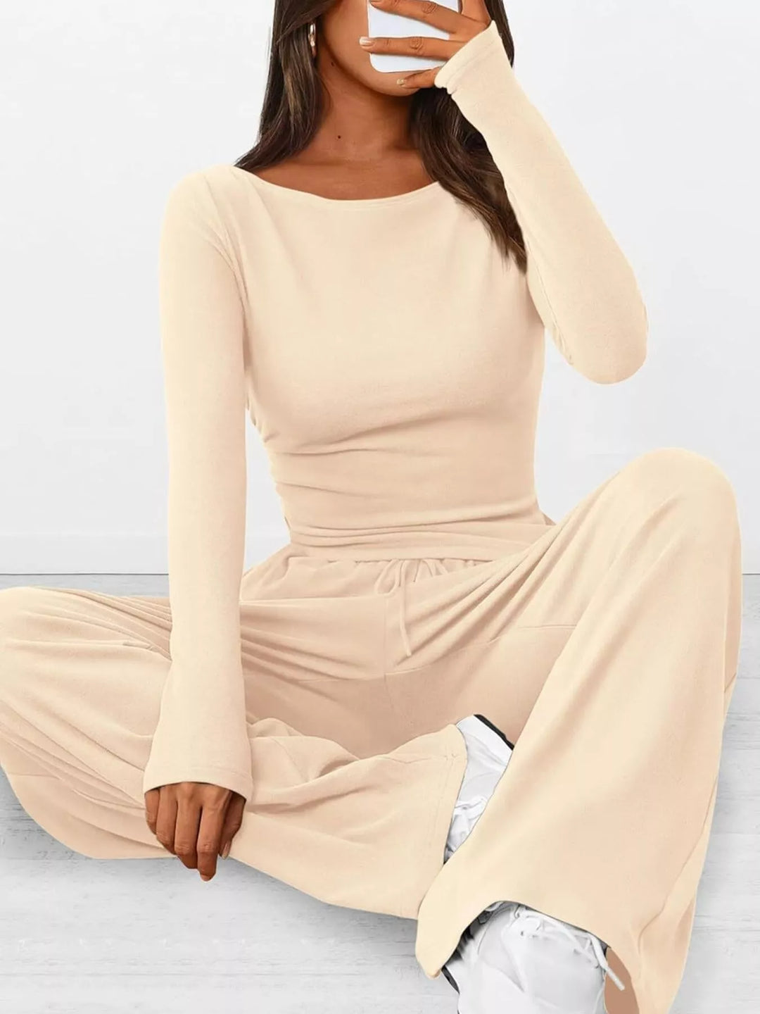 Cream ribbed lounge set, seated on the floor in a relaxed pose
