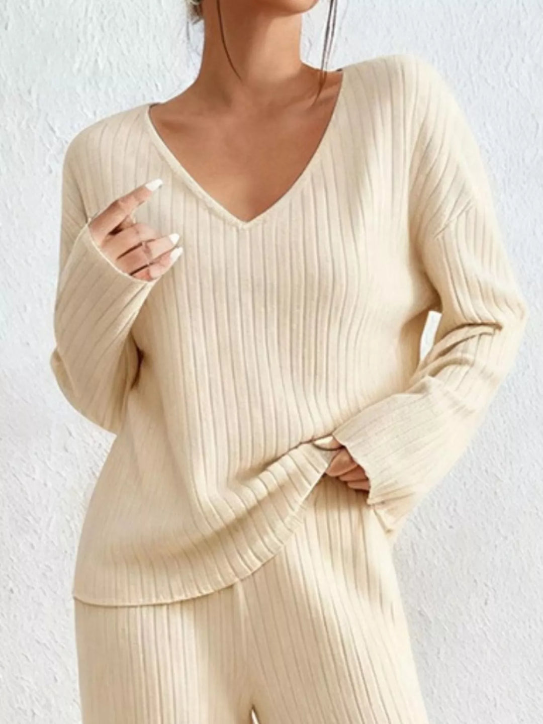 Cream v neck ribbed top, close view of the neckline and sleeves