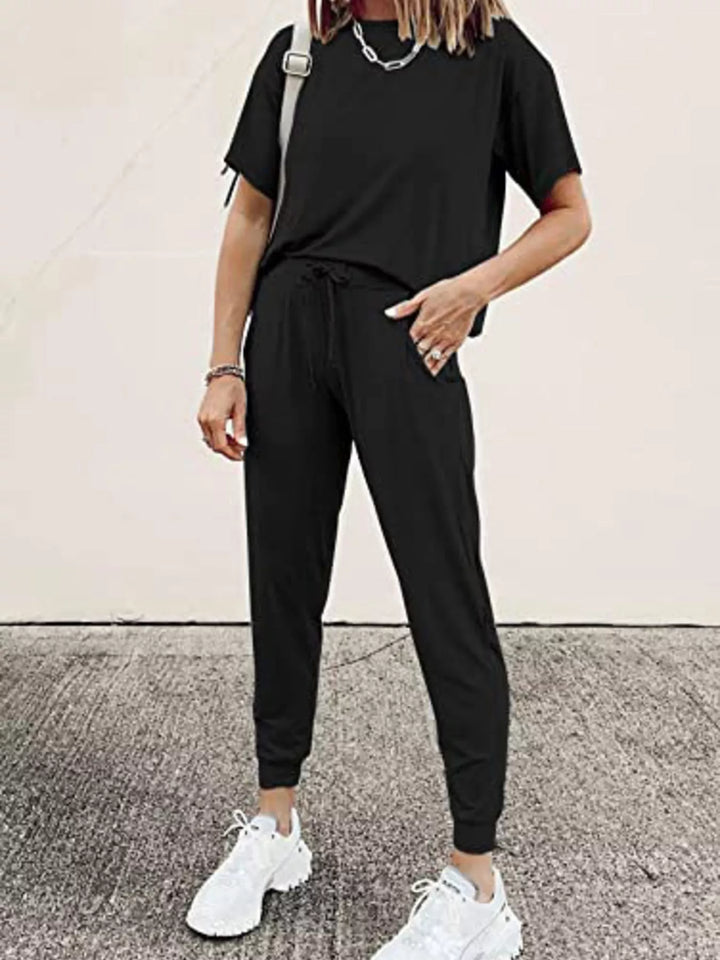Black lounge set with short sleeve tee and jogger pants, hands in pockets