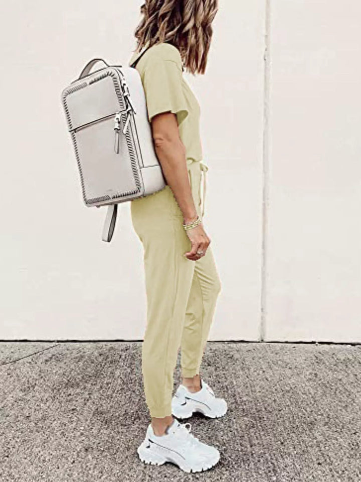 Butter yellow tee and joggers outfit with a white backpack, side view