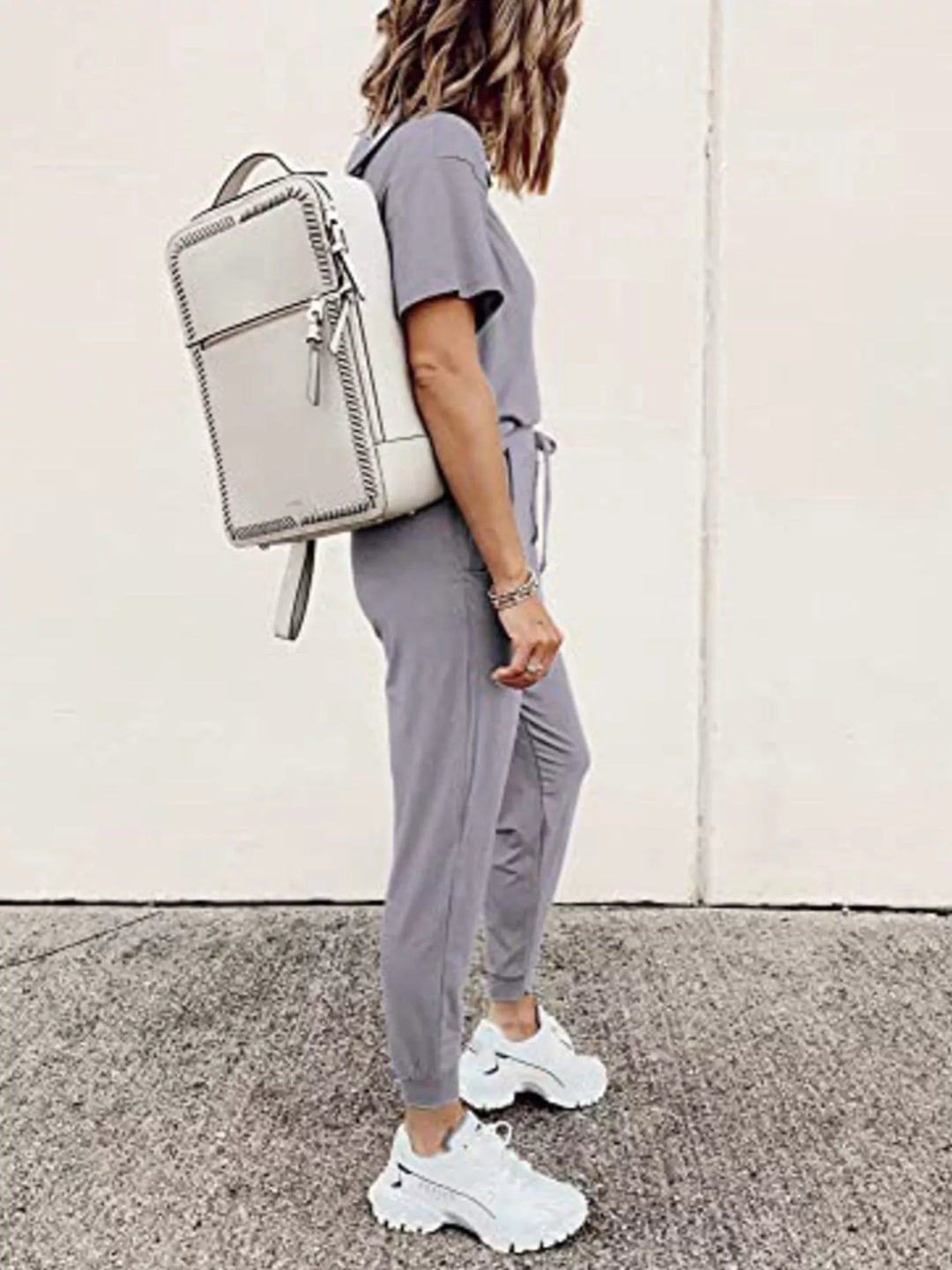 Lilac gray short sleeve tee and jogger pants, side view with backpack