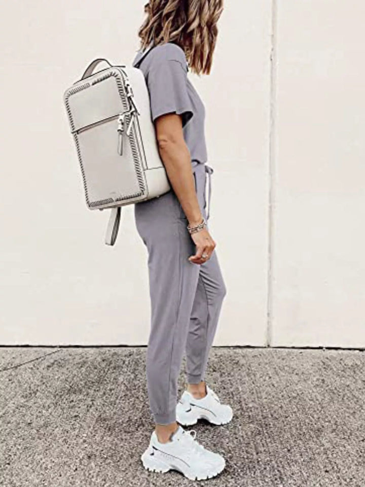 Lilac gray short sleeve tee and jogger pants, side view with backpack
