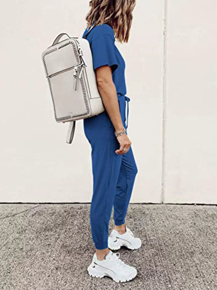 Royal blue jogger set side view with a white backpack on the shoulder