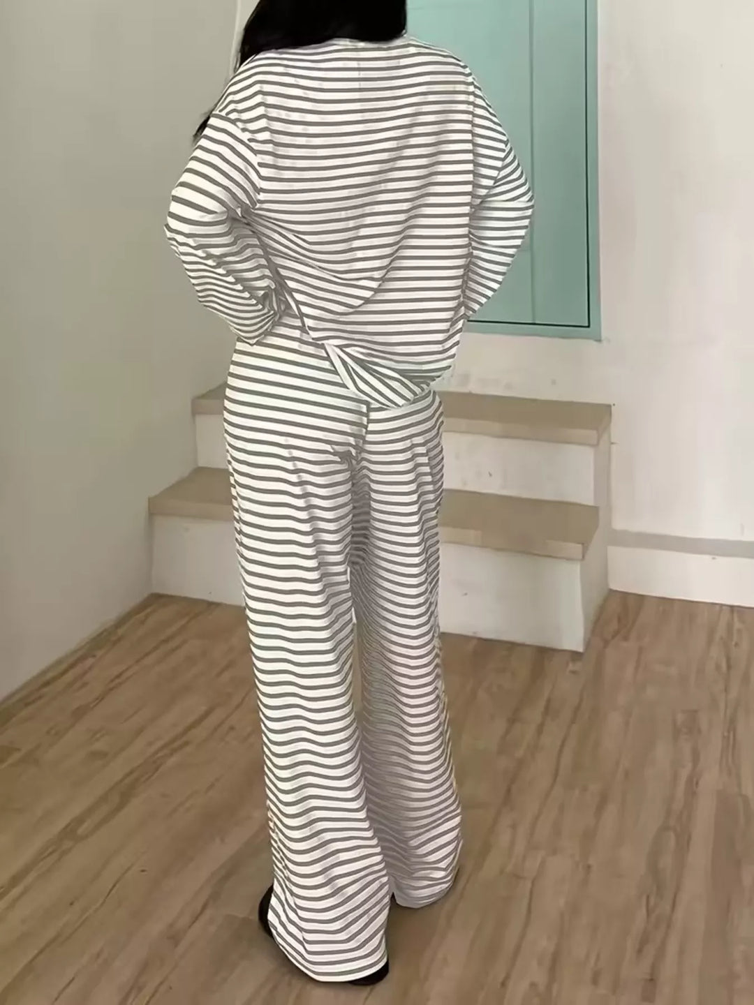 Back view of the gray striped long sleeve top and drawstring pants