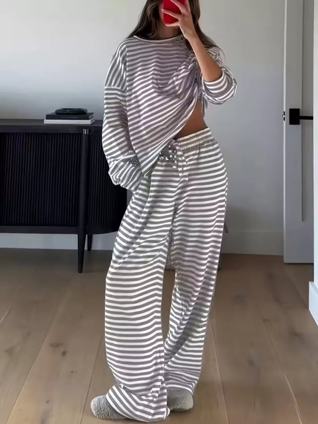 Full length view of the gray striped lounge set in a bedroom, mirror selfie