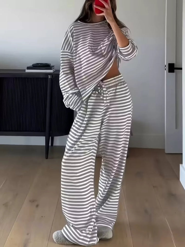 Full length view of the gray striped lounge set in a bedroom, mirror selfie