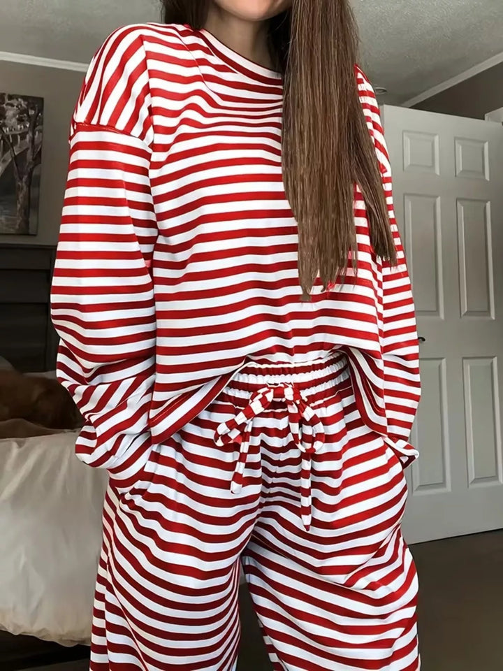 Red striped lounge set worn with hands in pockets, close front view