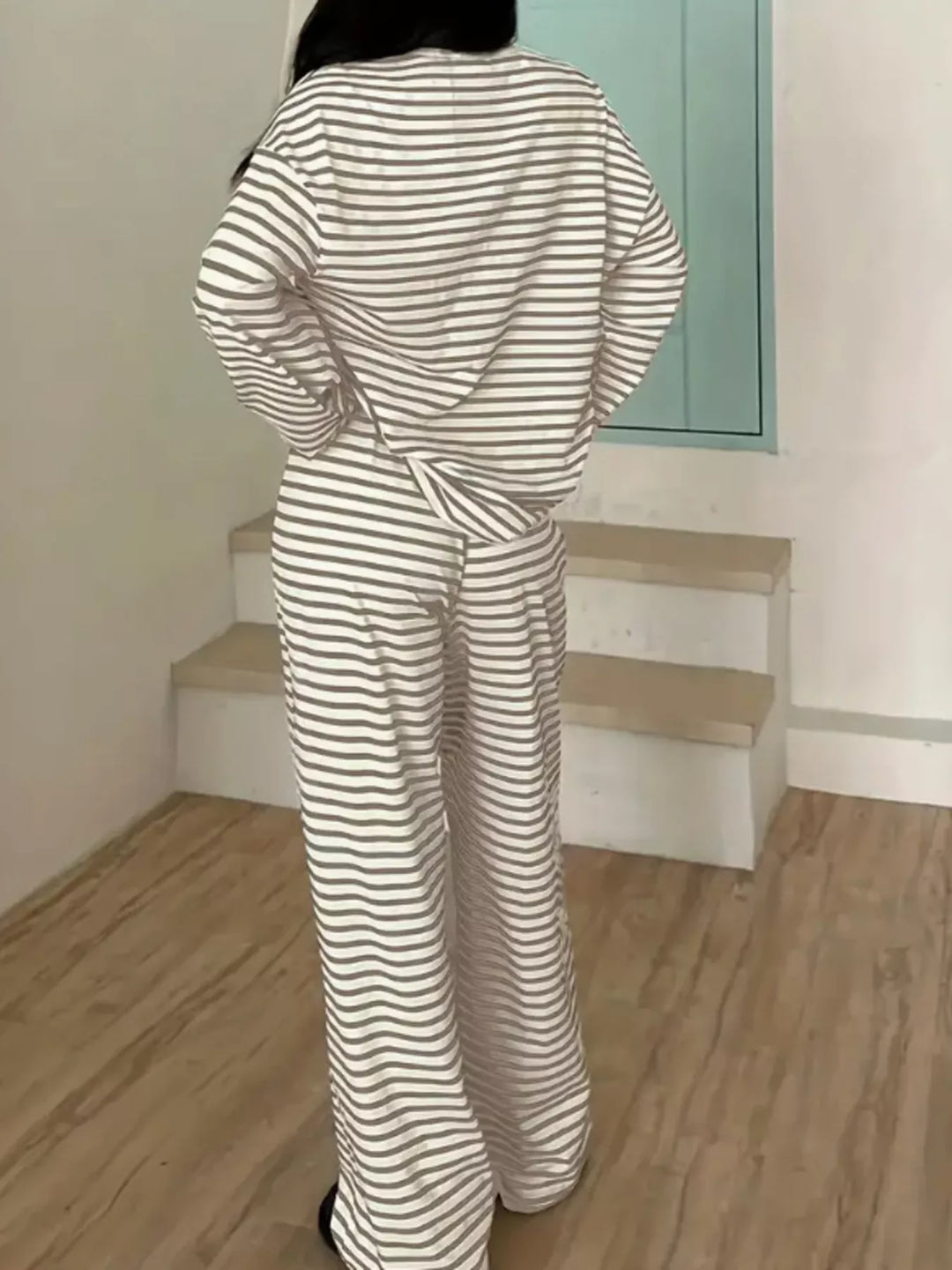 Back view of the taupe striped lounge set top and wide leg pants
