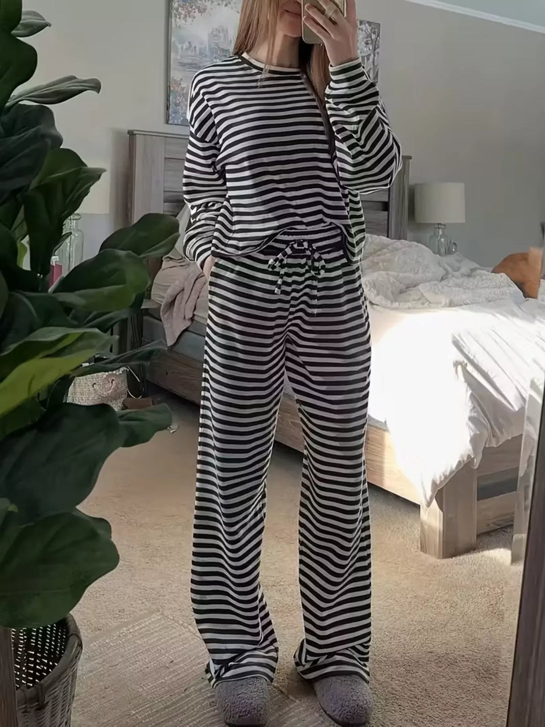 Black striped oversized top and wide leg pants set standing in a bedroom